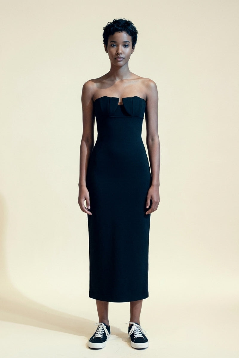Black strapless structured-bust dress with sleek silhouette.