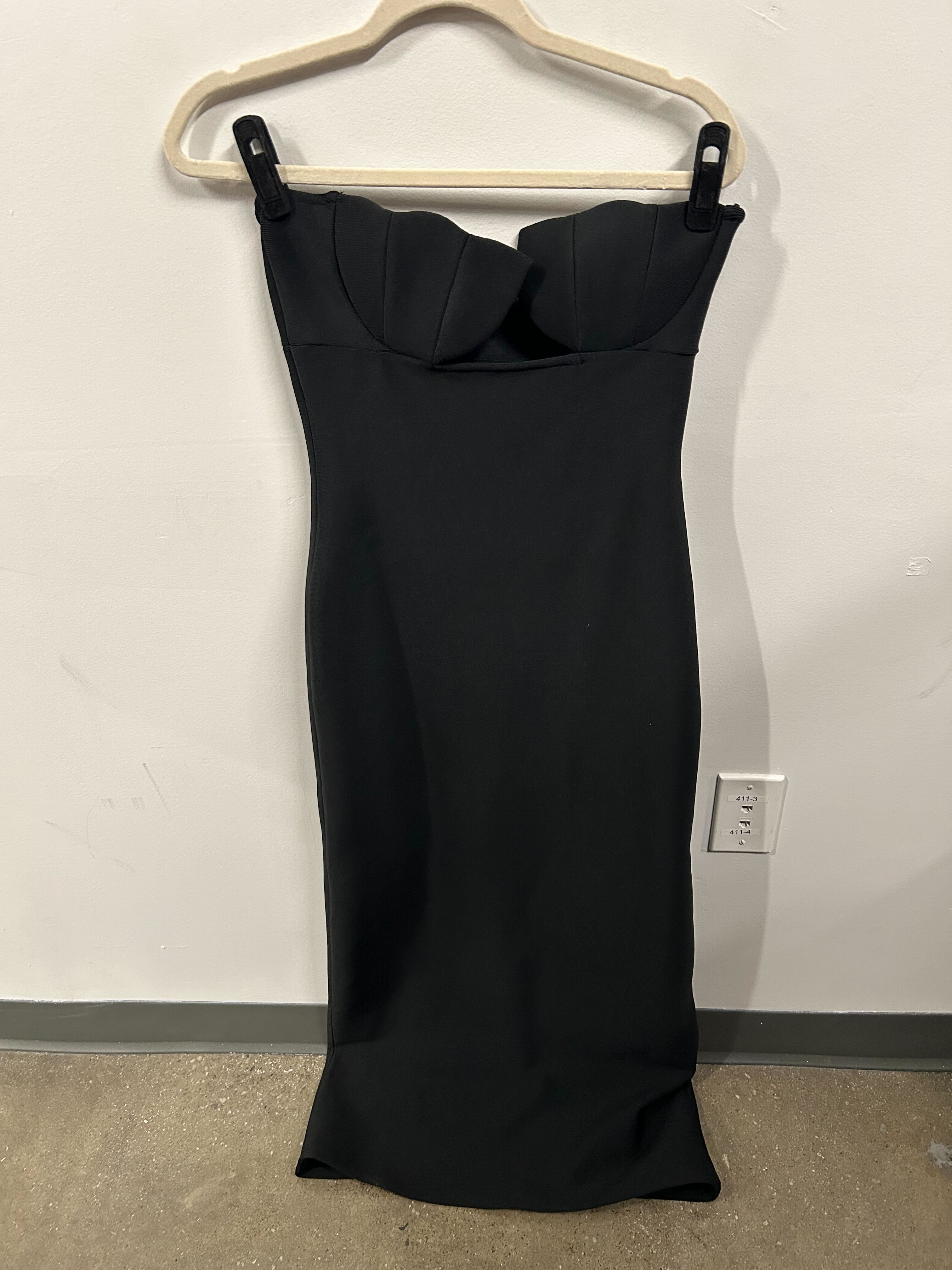Black strapless structured-bust dress with sleek silhouette.