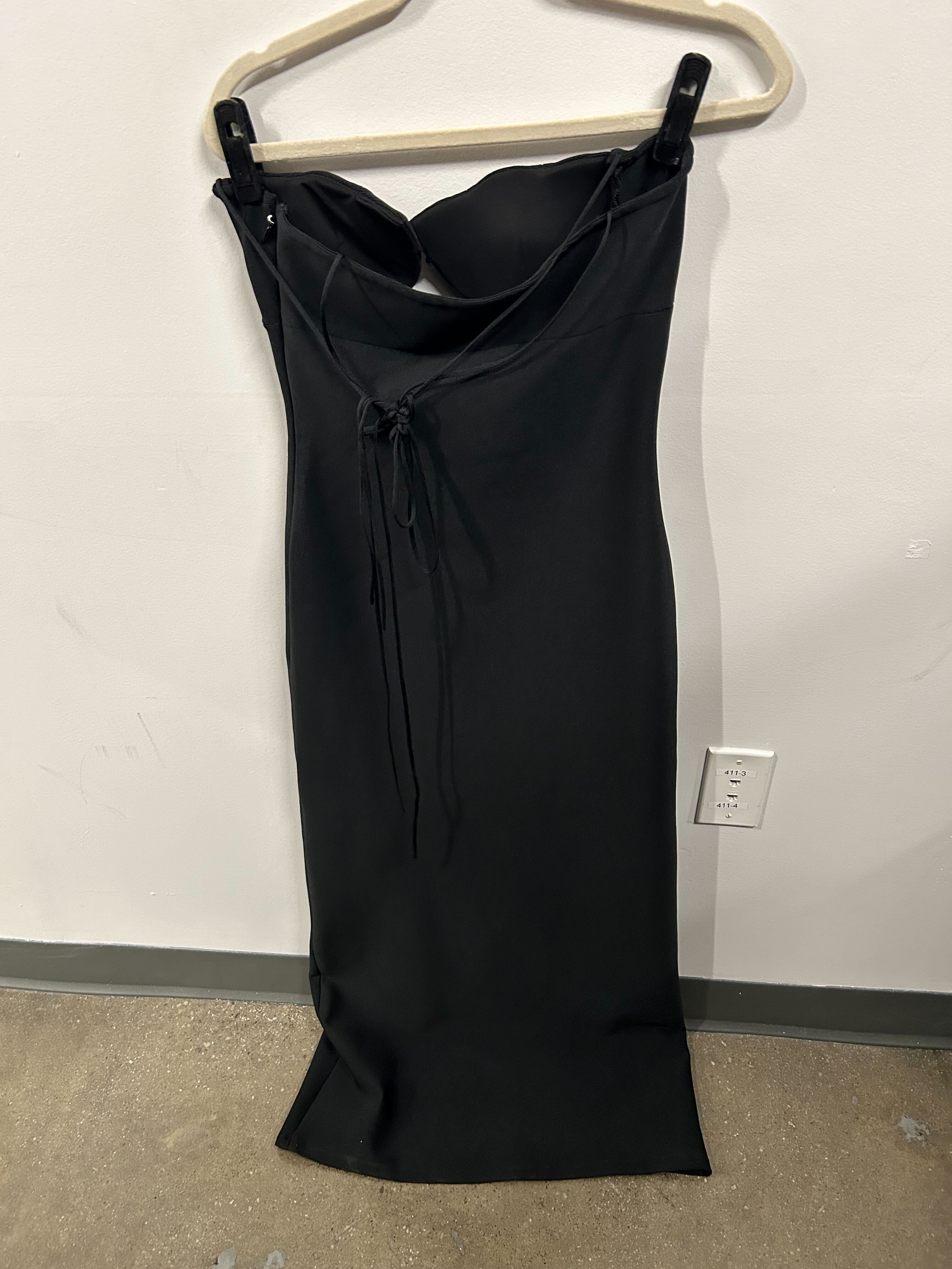 Black strapless structured-bust dress with sleek silhouette.