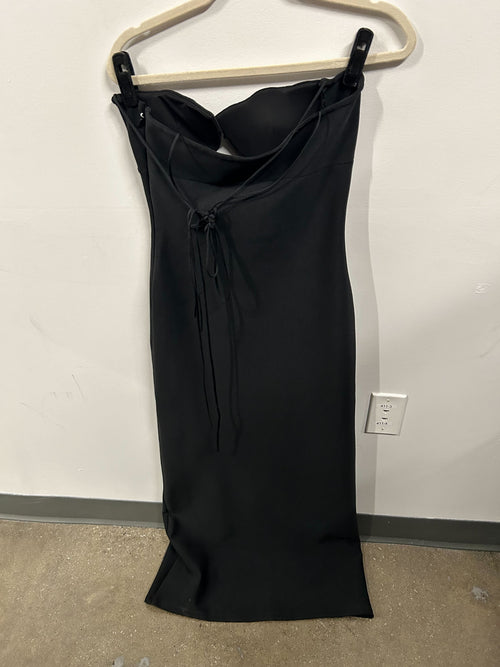 Black strapless structured-bust dress with sleek silhouette.